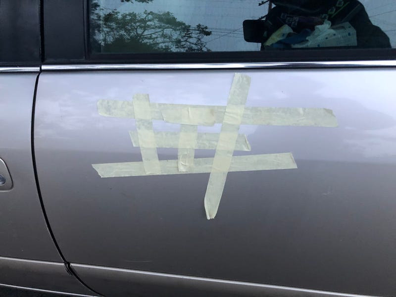 Tuesday morning, the swastikas had mostly been covered over by tape or cardboard. 