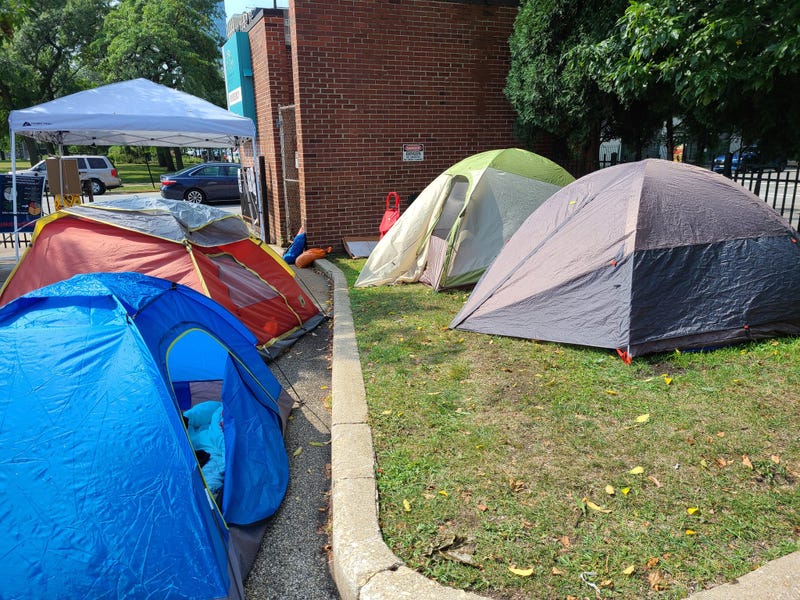 Four tents in a parking lot