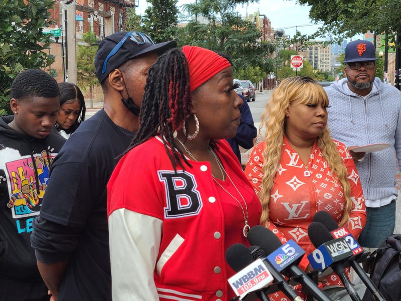 Family stands at a microphone