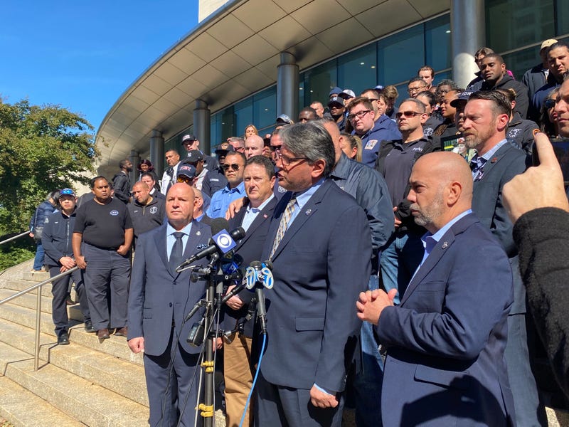 Colleagues of FDNY EMS Capt. Alison Russo stand with her brother, Craig Fuoco, at the Queens Criminal Courthouse on Thursday