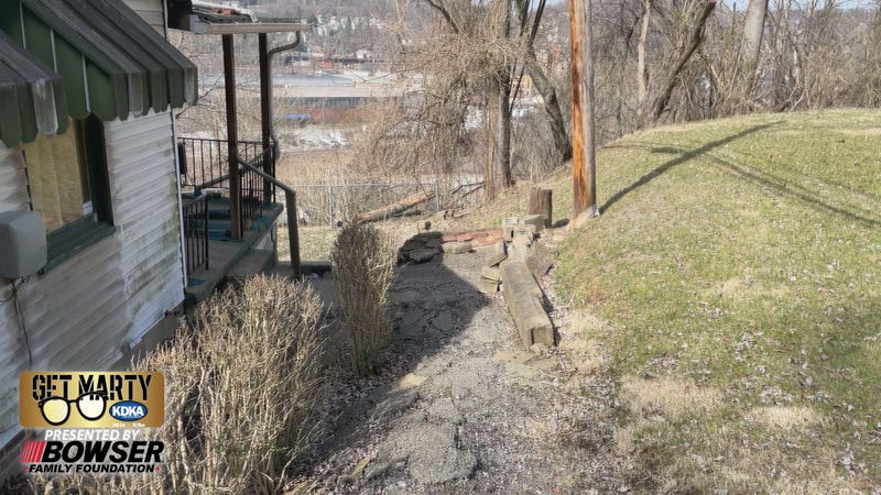 Crumbling retaining wall and walkway outside the home in North Versailles.