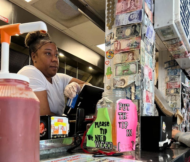 Toni Morris, who's worked at the Wiener's Circle for 23 years, listens to a customer as they order food.