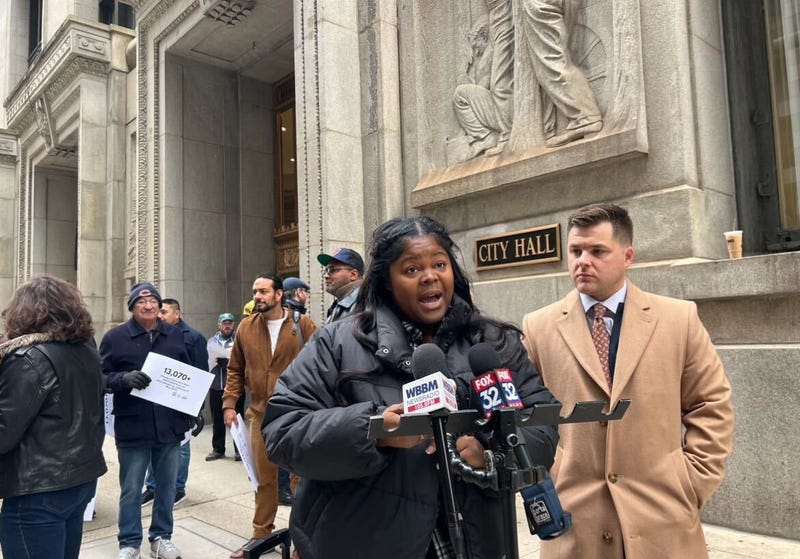 Ceresa Cohran speaks to the media outside Chicago City Hall on Nov. 20, 2024. Cohran, a former rideshare driver, is suing Uber, Lyft and the city of Chicago after she said she was wrongful deactivated as a driver for the rideshare services.