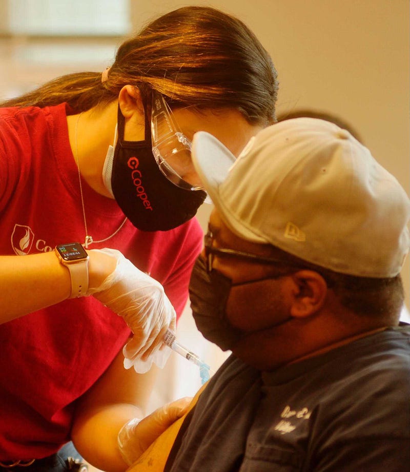 A Cooper Hospital nurse vaccinates a resident of The Branches at Centerville in Camden, N.J.