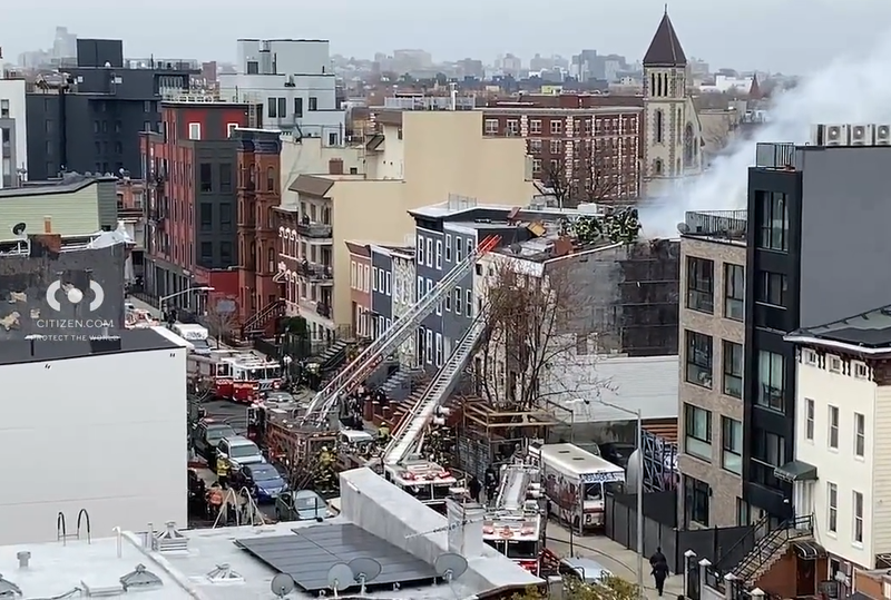 Video shows firefighters on the roof of the four-story residential building