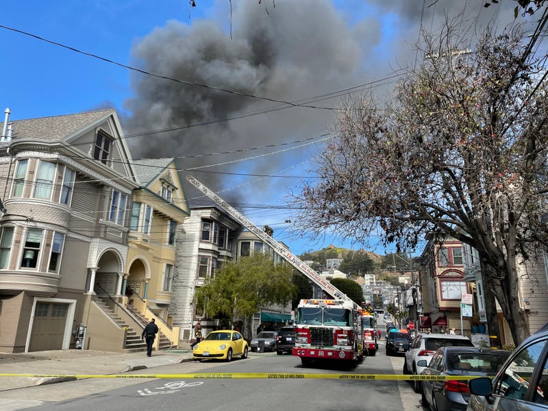 San Francisco Fire Department crews battle flames at 112 Eureka St. on Friday afternoon.
