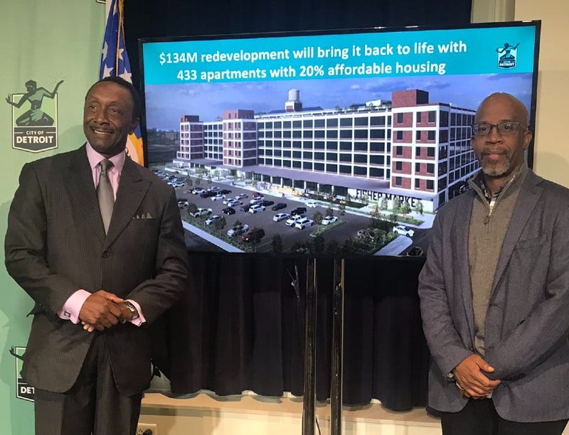 Greg Jackson and Richard Hosey with a rendering of the Fisher 21 Lofts