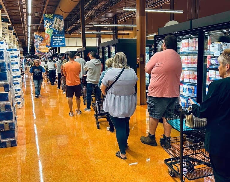 A long line inside the Losson Rd Wegmans store Friday for the Fisher Price 'Bills Little People' collector sets