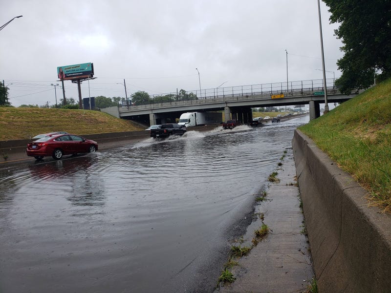 Standing water along Eastbound I-94 in Detroit, at Conner, making travel a slow go. Traffic getting by only in left lane.