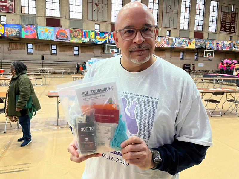 Scott Charles, Temple Hospital’s trauma outreach manager, holds a gun violence prevention kit that volunteers are making during the 28th annual Greater Philadelphia MLK Day of Service at Girard College, Jan. 16, 2023.
