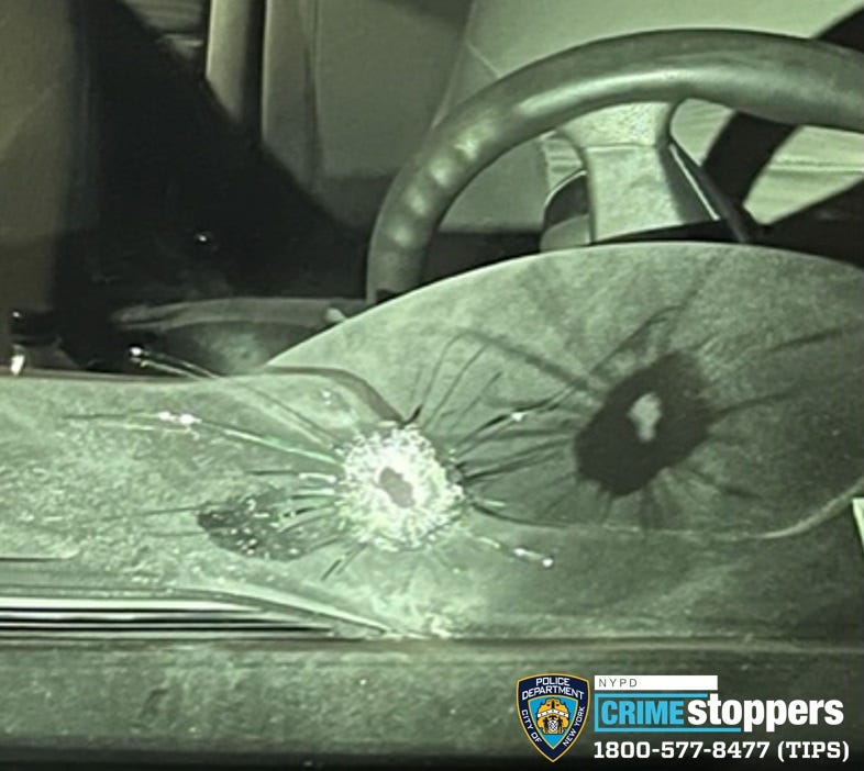 A bullet entered the windshield of an unmarked patrol car and struck an NYPD officer in his upper left arm, police said