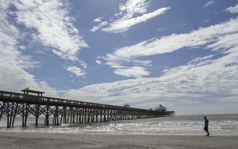 Sep. 14, 2018; Charleston, SC, USA; Beach goers walk the shoreline as winds from Hurricane Florence increase near Folly Beach Fishing Pier in Charleston.