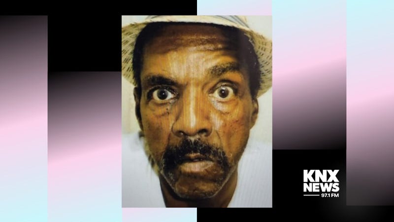 black man with mustache wearing hat