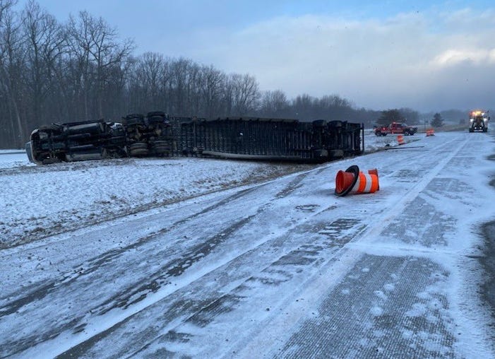 A semi truck that flipped over and closed down both directions of I-69 on Saturday was discovered hauling "dangerous goods," authorities in Lapeer announced.