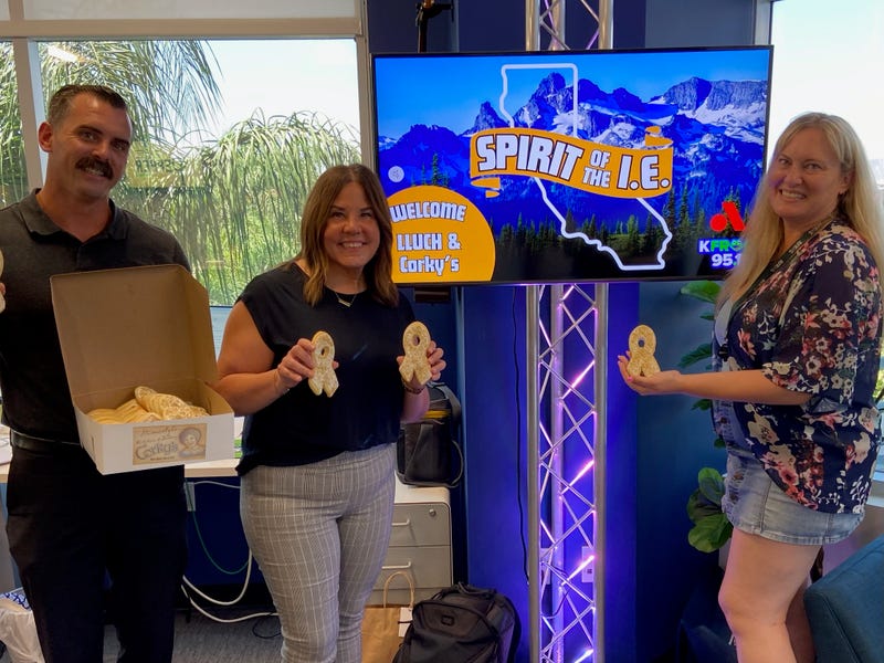 Corky's Darin Handlen, LLUCH's Scarlett Czarnecki and K-Frog's Pepper with Corky's gold ribbon cookies