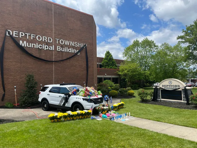 Deptford Police Officer Robert Shisler's patrol car has been covered in flowers, flags and other tributes to the 27-year-old, May 9, 2023, Deptford Township, New Jersey. 