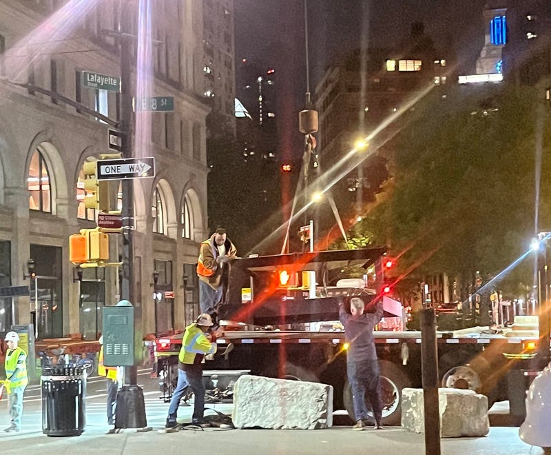 The base of The Cube is loaded onto a flatbed truck for transport