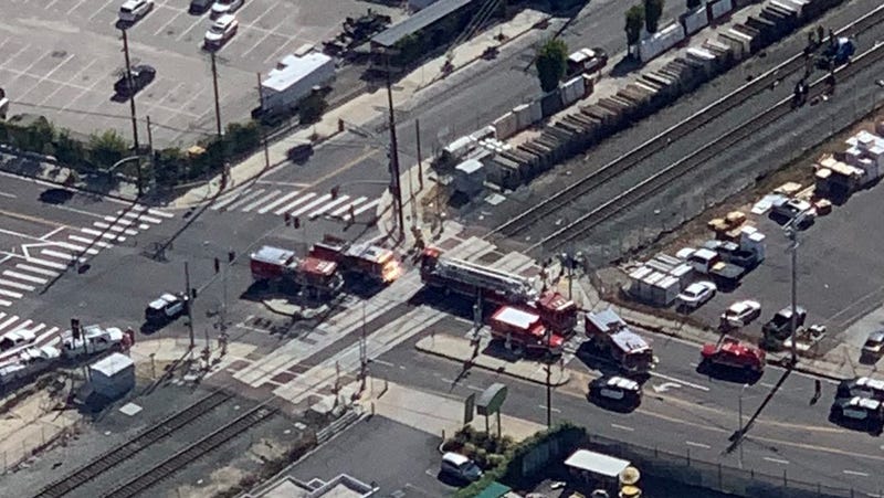 fire trucks surround train tracks