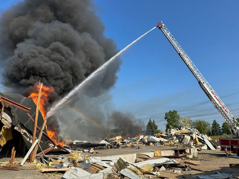 Heavy equipment sparks billowing debris fire during demolition of building in West Bloomfield