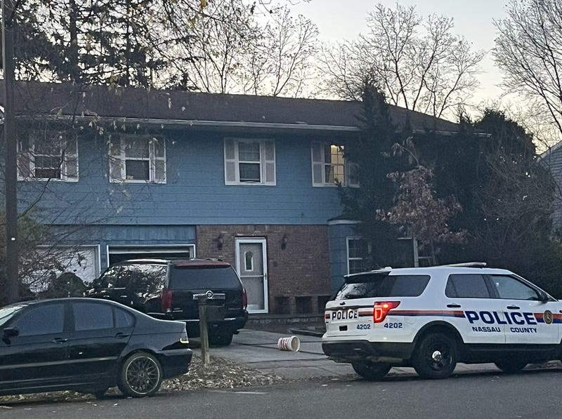 A Nassau police cruiser remained outside the home in Woodbury on Wednesday morning