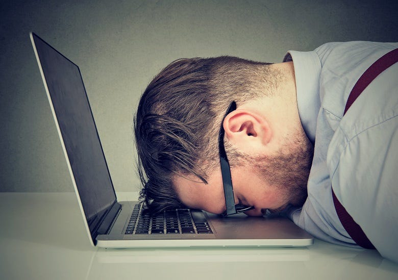 Dude with head on laptop