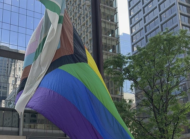 Local officials raised the Progress Pride flag in downtown Chicago on Monday.