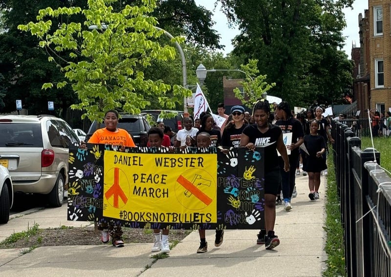 School officials from Daniel Webster Elementary and a police escort led students on their march through the streets of North Lawndale on Tuesday.