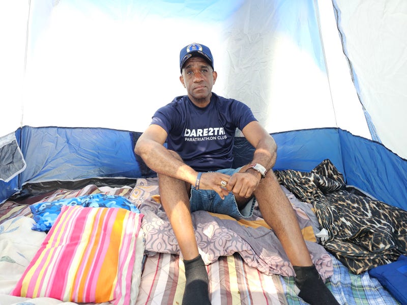 Alderman David Moore sitting inside tent