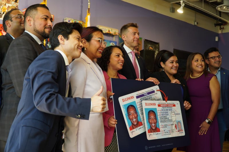 Illinois Secretary of State Alexi Giannoulias and several others pose for a photo on Monday after an announcement that undocumented immigrants in Chicago and Illinois will now be able to apply for a standard driver's license.