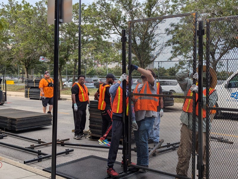 workers assemble fencing