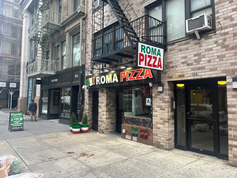 Blood was still on the sidewalk outside Roma Pizza on Tuesday morning