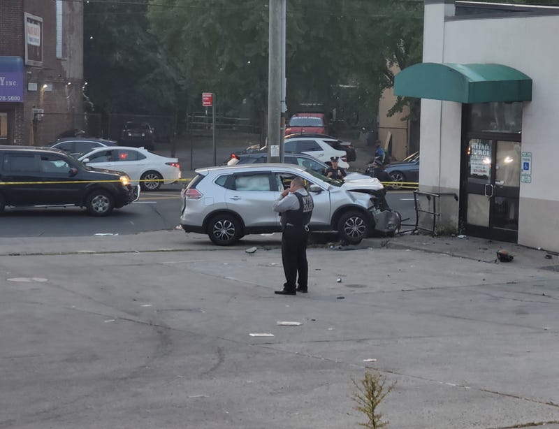 The driver struck a woman and mounted a sidewalk after being shot in the head, police said
