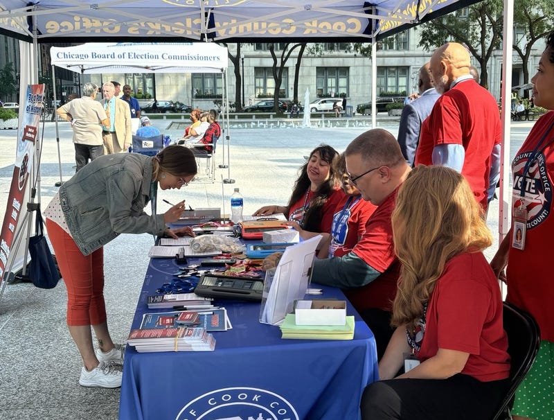 Workers with the Cook County Clerk's Office get local residents registered to vote in the 2024 election.