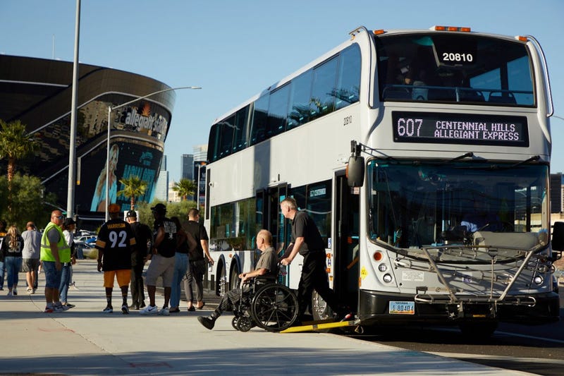 Riders depart an RTC Game Day Express bus outside of Allegiant Stadium