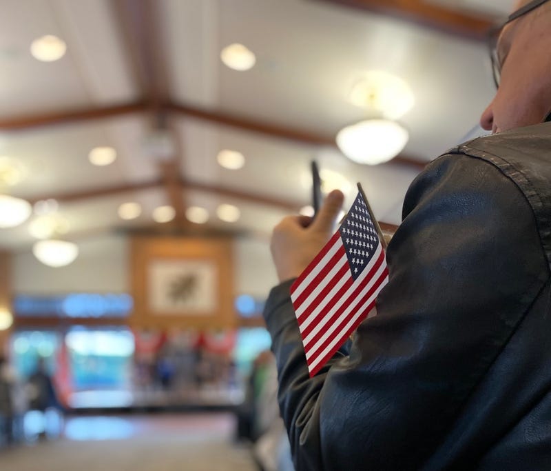 One of the 77 people who were sworn is as U.S. citizens during a naturalization ceremony in Wheaton, Ill., on Monday.