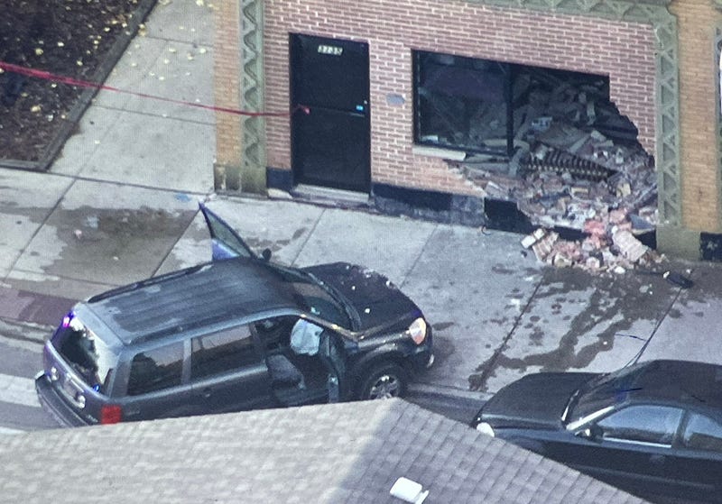 shot up car crashed into brick building