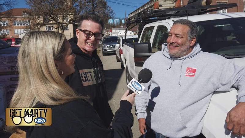 Grateful veteran Kenneth Snead talks to Marty Griffin and Arianna Bazzy while his new roof is being installed.