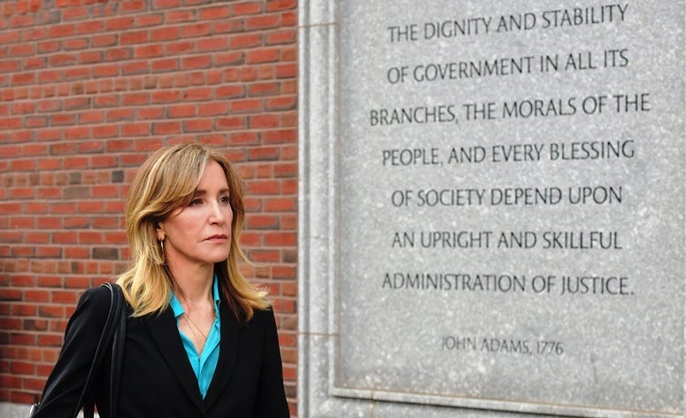 Felicity Huffman exits the John Joseph Moakley U.S. Courthouse after appearing in Federal Court to answer charges stemming from college admissions scandal on April 3, 2019