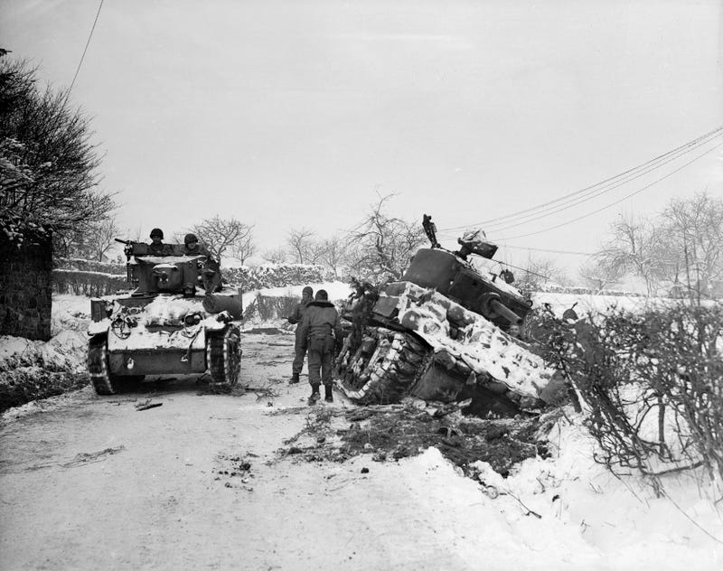January 1945: Hard going for US tanks at Amonines, Belgium, on the northern flank of the 'battle of the bulge'. A tank on the road passes another being dug out of the snow.