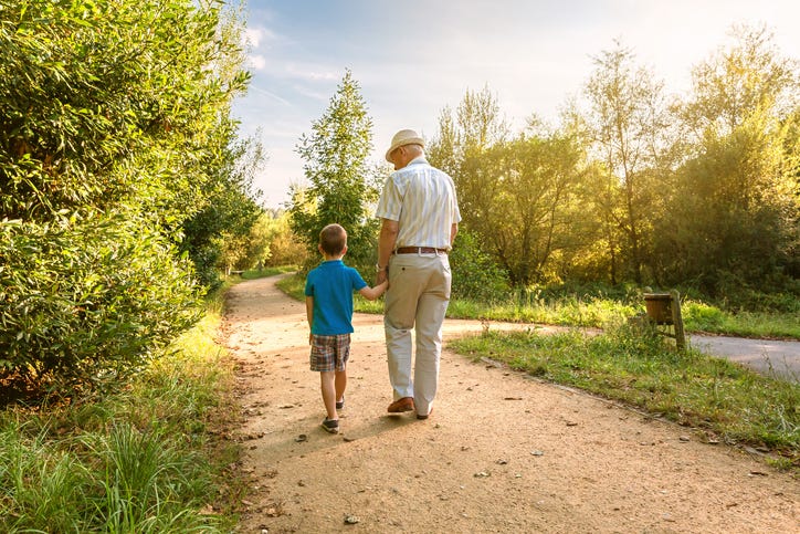 Grandparent and grandson walking. 