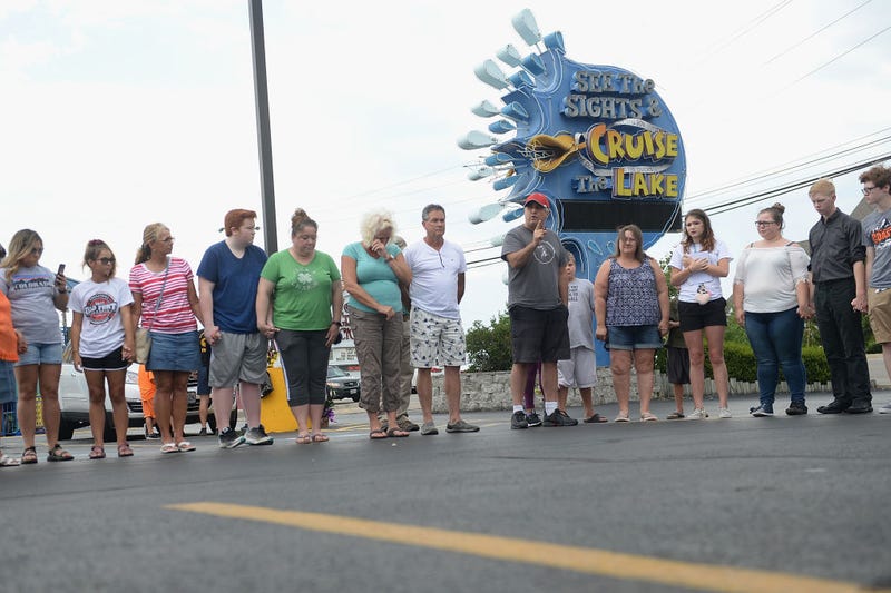 A group of mourners pause for a moment of prayer and remembrance of the victims of the Ride The Ducks accident at Ride The Ducks Tours on July 20, 2018 in Branson, Missouri.