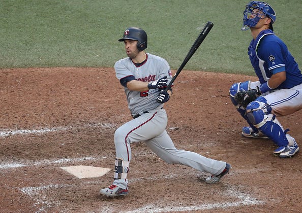Brian Dozier #2 of the Minnesota Twins hits a double in the eleventh inning during MLB game action against the Toronto Blue Jays at Rogers Centre on July 25, 2018 in Toronto, Canada. 