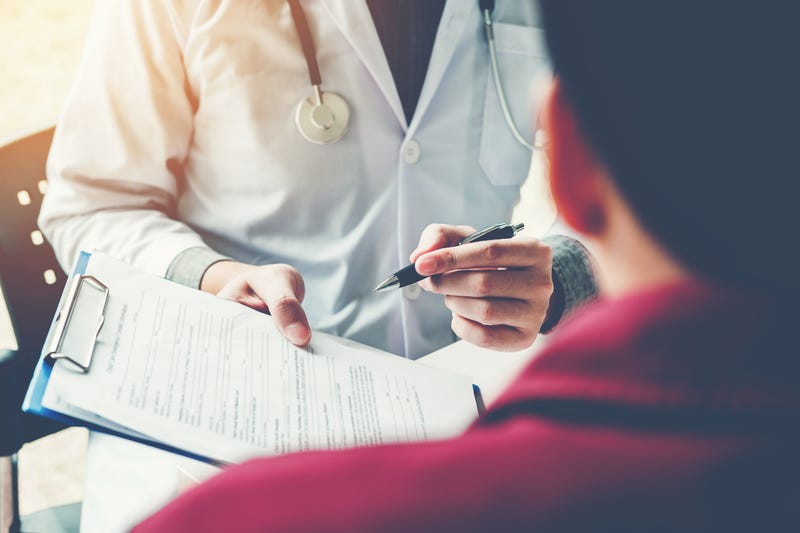 person filling out medical form