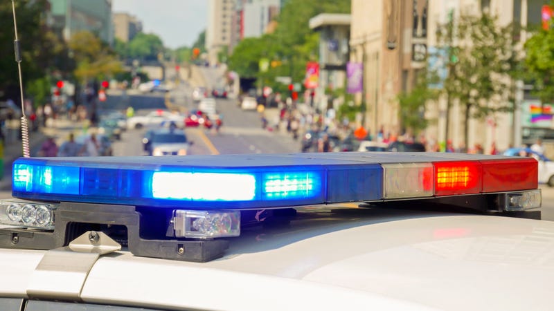 A police car rushes to the emergency call with lights turned on.