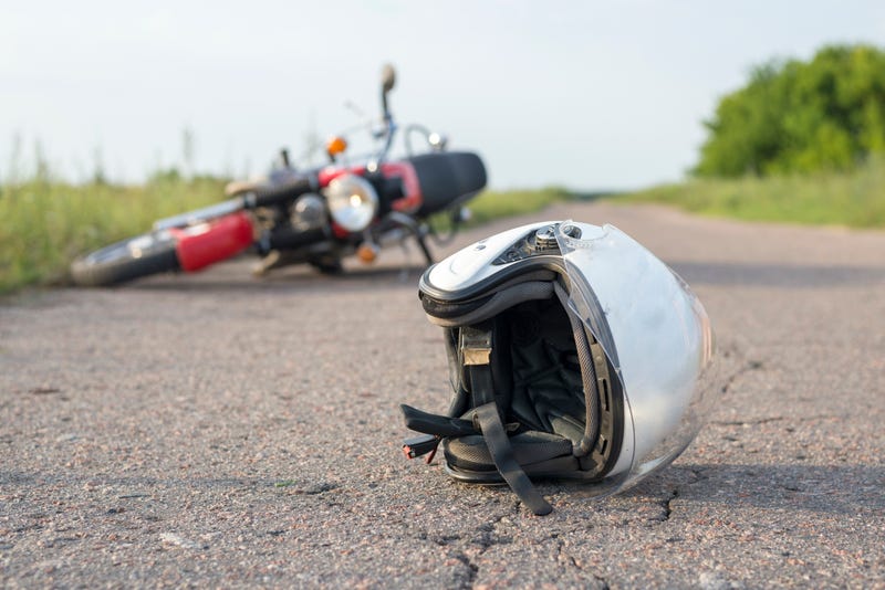 Motorcycle and helmet laying in road