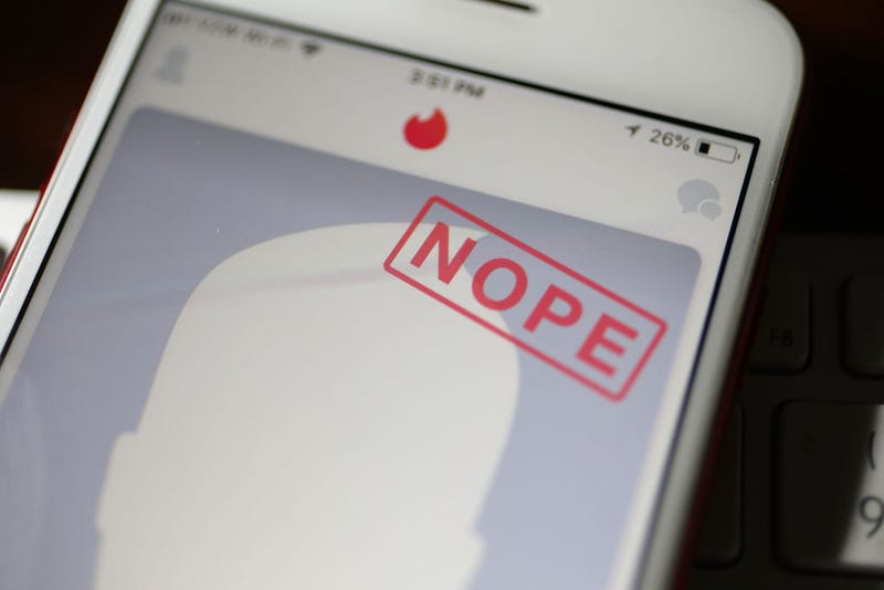 A mobile phone screen showing a dating app with the word "Nope"