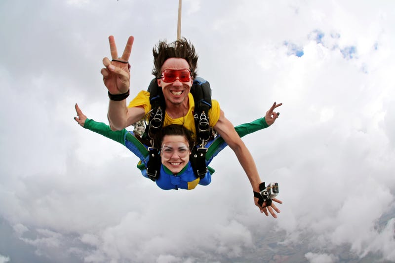 Skydiving tandem happiness on a cloudy day