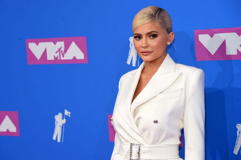 Kylie Jenner Rocks a Revealing Red Bow to Promote Holiday Makeup Line