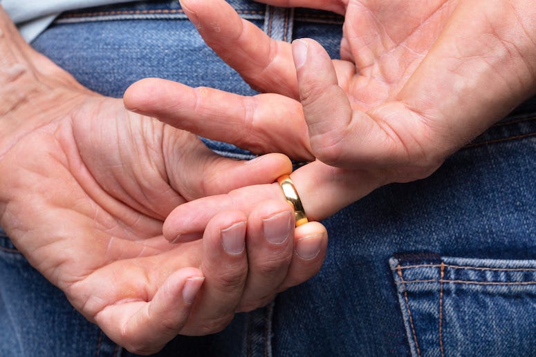 Man taking off wedding ring