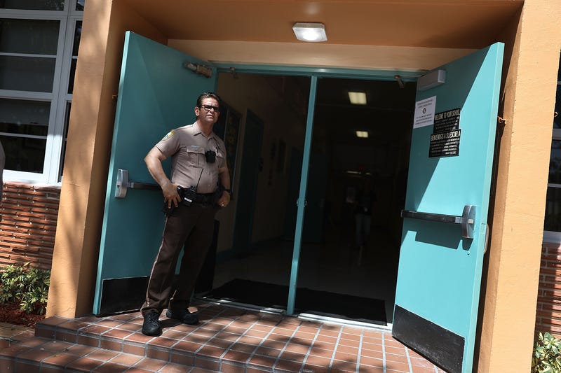 Police officer standing at school doors
